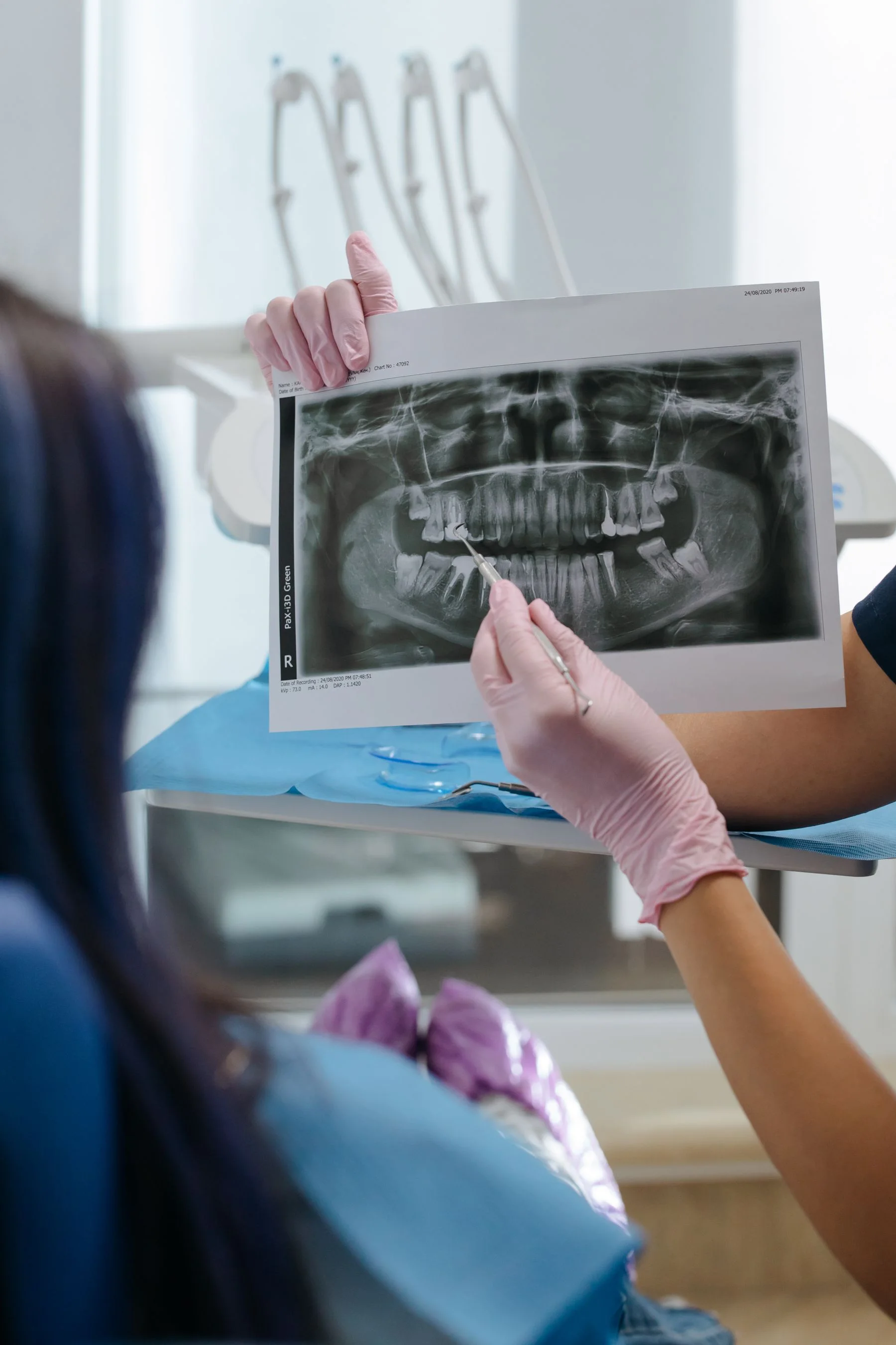 Dental clinician reviewing diagnostic imaging with a patient